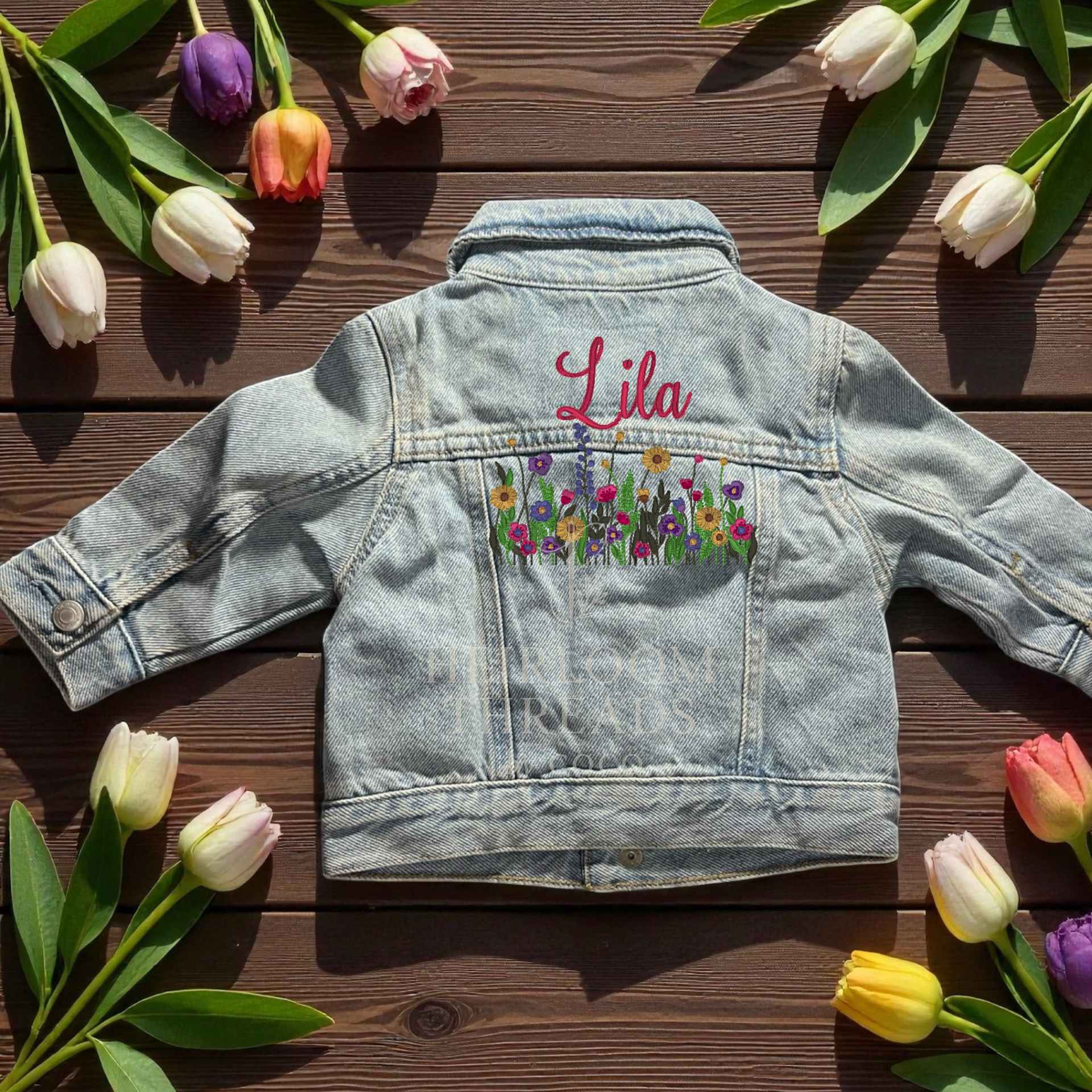 Custom embroidered infant and toddler denim jean jacket with colorful stitched design. Available in sizes 0-3 months through 4T with Floral, Bow Swag. Care Instructions: Machine wash and lay flat to dry.