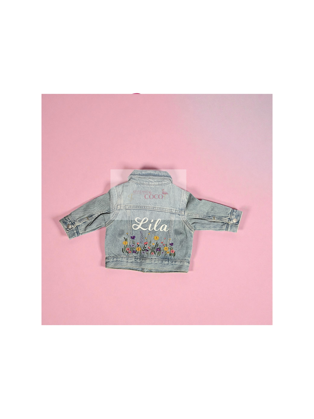 Light denim jean jacket featuring a custom embroidered name and colorful stitched flowers.