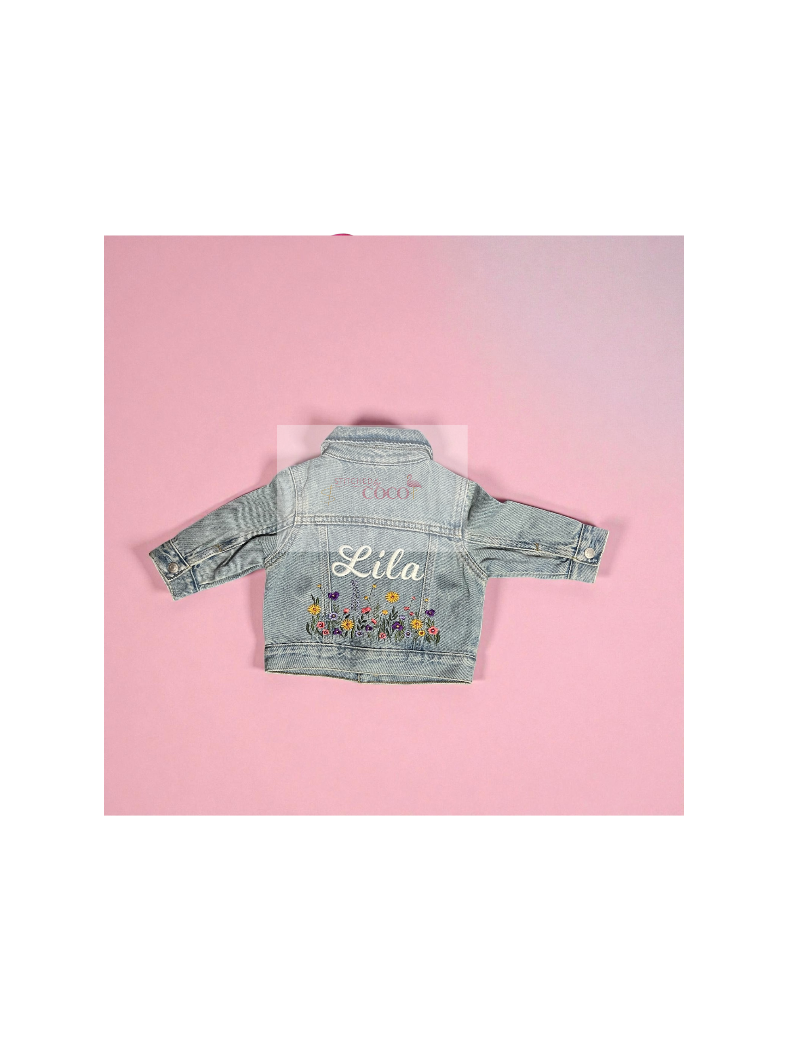 Light denim jean jacket featuring a custom embroidered name and colorful stitched flowers.
